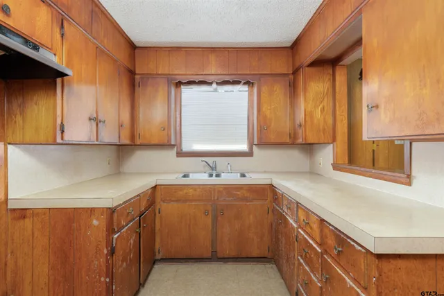 a kitchen with sink cabinets and window