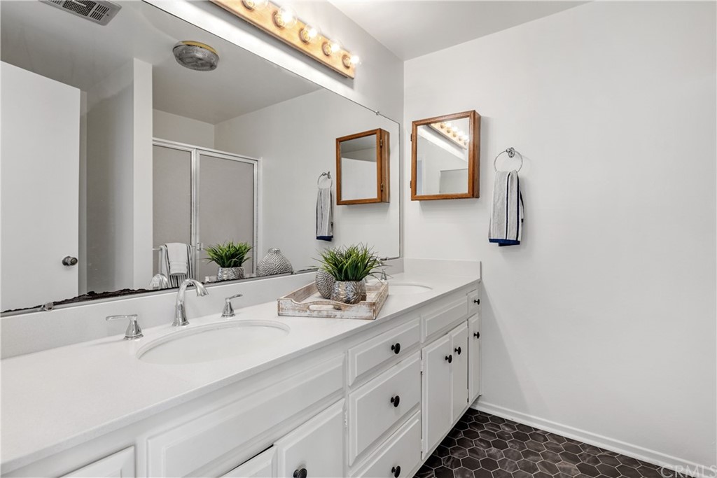 259 Valley Drive Hermosa Beach, CA 90254 - Photo 23 of 34 a bathroom with a double vanity sink and mirror