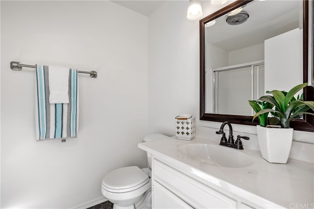 259 Valley Drive Hermosa Beach, CA 90254 - Photo 26 of 34 a bathroom with a toilet a sink and mirror