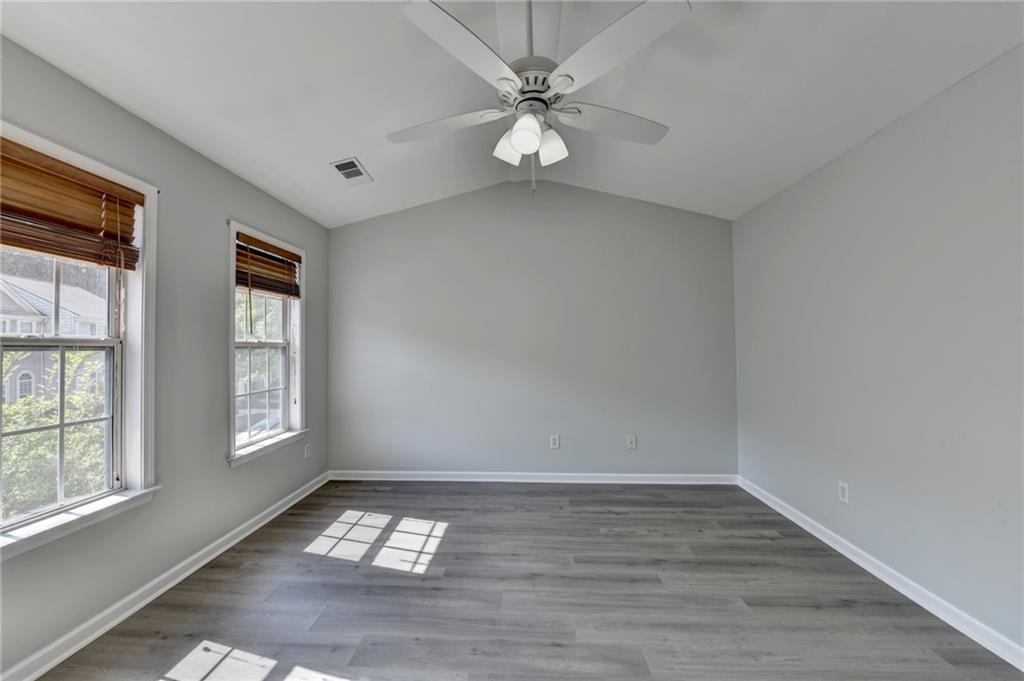 3977 Howell Park Road Duluth, GA 30096 - Photo 22 of 25 wooden floor in an empty room with a window