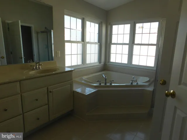 a bathroom with a tub and toilet