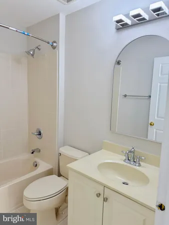 a bathroom with a sink toilet vanity and shower
