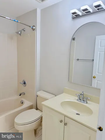 a bathroom with a sink toilet vanity and shower