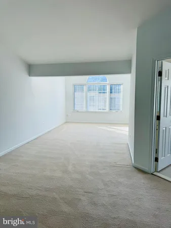 an empty room with a empty space and windows