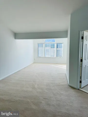 an empty room with a empty space and windows