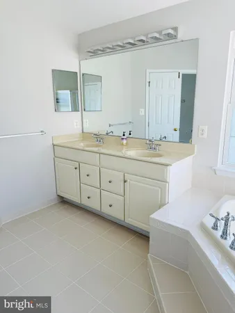 a spacious bathroom with a double vanity sink mirror and