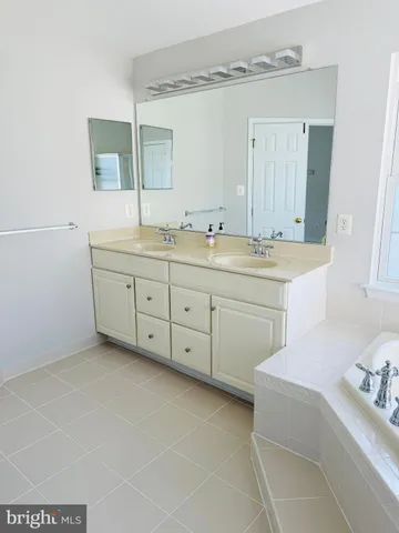 a spacious bathroom with a double vanity sink mirror and