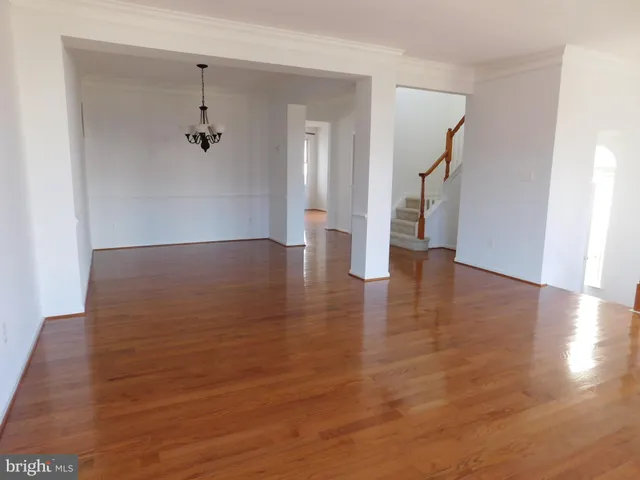 a view of a room with wooden floor