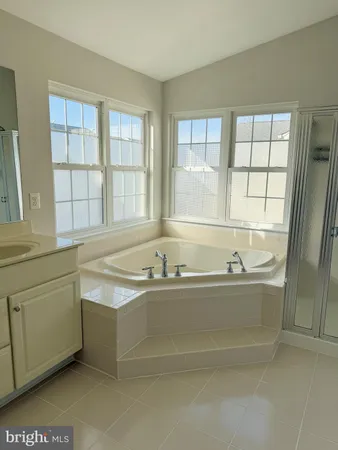 a bath tub sitting in a bathroom next to a window