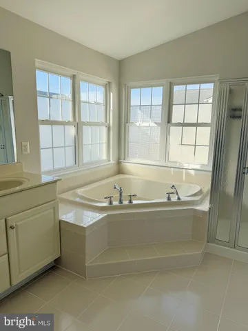 a bath tub sitting in a bathroom next to a window