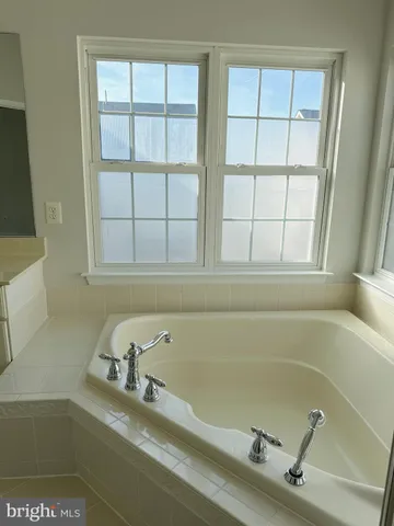 a bath tub sitting next to a window