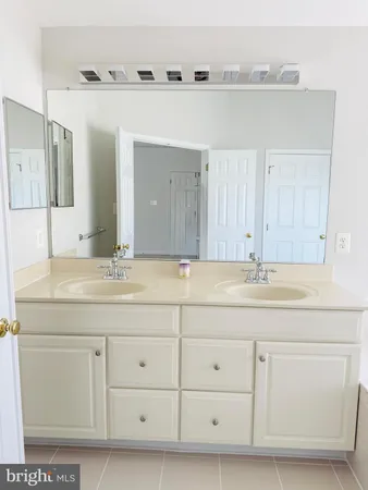 a bathroom with a sink vanity and mirror