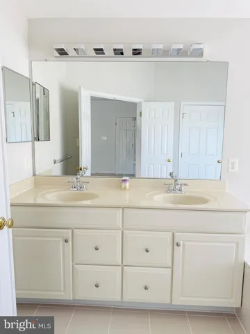 a bathroom with a sink vanity and mirror
