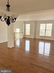 a view of an empty room with a fireplace and a window