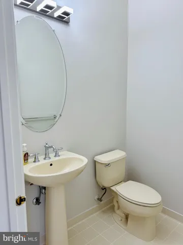 a bathroom with a sink toilet and a mirror