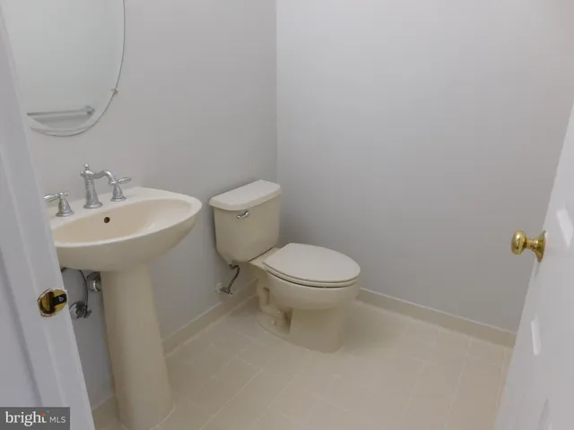 an empty room with wooden floor fireplace and windows