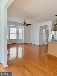 a view of a kitchen with kitchen island a sink stainless steel appliances and cabinets