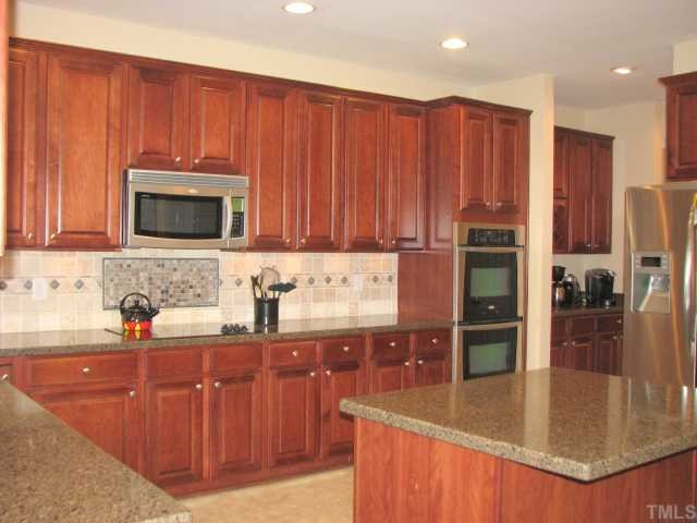 125 Locke Woods Road Raleigh, NC 27603 - Photo 3 of 12 What a rare treat to have a home with real double ovens AND a microwave! A wet bar and built-in wine rack are located between the kitchen and the dining room.