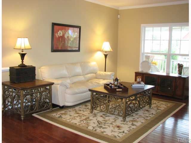 125 Locke Woods Road Raleigh, NC 27603 - Photo 6 of 12 The living room is open to the dining room and enjoys hardwood floors, decorative columns, distributed audio, and a view of the golf course.