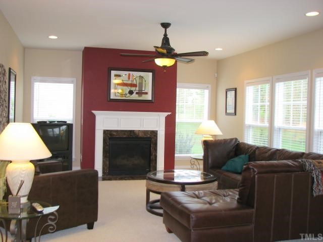 125 Locke Woods Road Raleigh, NC 27603 - Photo 7 of 12 The family room features a gas fireplace, recessed lighting, crown molding and it is open to the breakfast room and kitchen area.