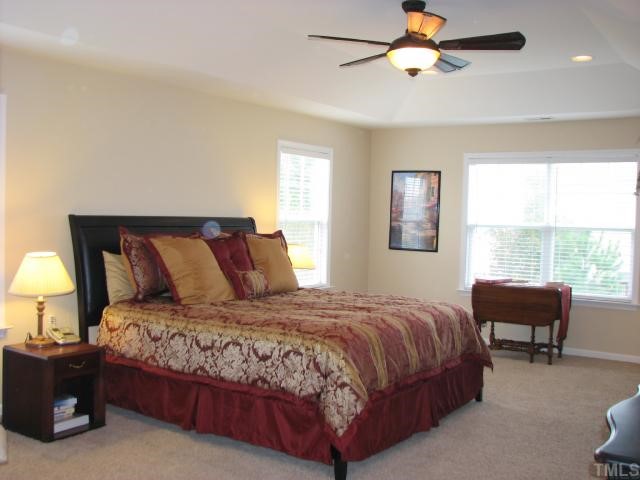 125 Locke Woods Road Raleigh, NC 27603 - Photo 8 of 12 The master retreat is filled with upgrades. You will love the dream walk-in closet that offers custom built-ins. Additional features include a trey ceiling, a ceiling fan, and recessed lighting.