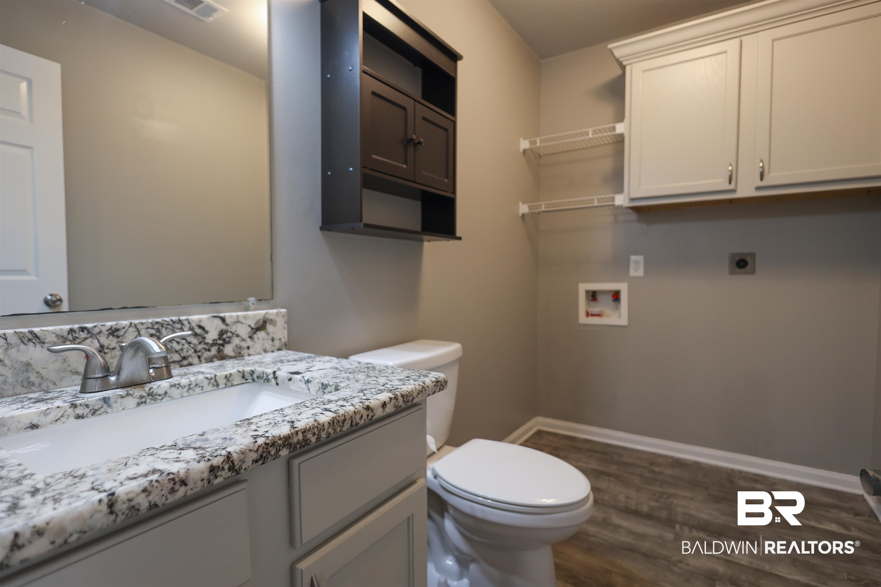 1517 Regency Road, Unit 125 Gulf Shores, AL 36542 - Photo 15 of 26 Bathroom with vanity and dark wood finished floors