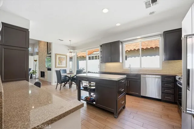 a kitchen with stainless steel appliances granite countertop a stove and a sink