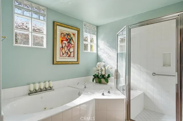 a bathroom with a tub sink and mirror