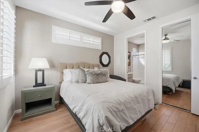 a bedroom with a bed and a lamp