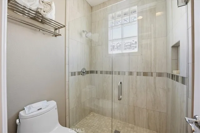 a bathroom with a toilet and a shower