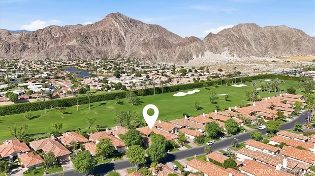 a view of a lush green hillside and houses