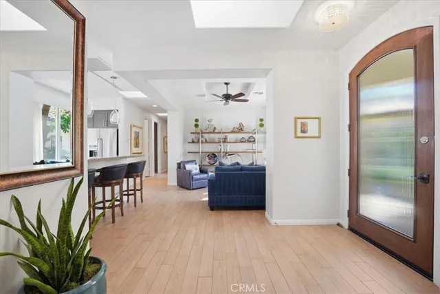 a living room with furniture and a floor to ceiling window