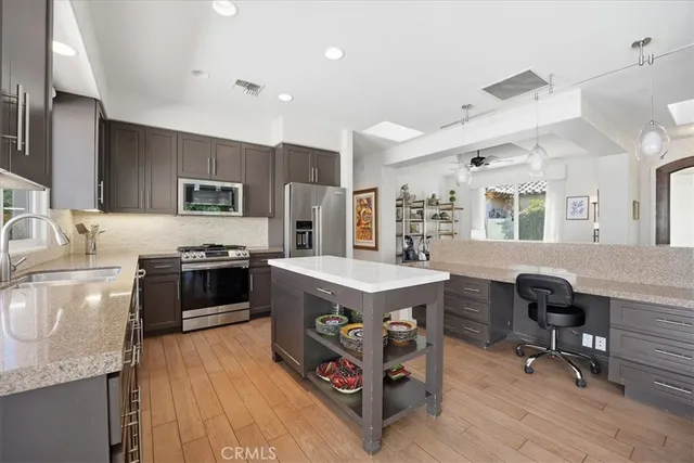 a kitchen that has a lot of cabinets a sink and a stove in it