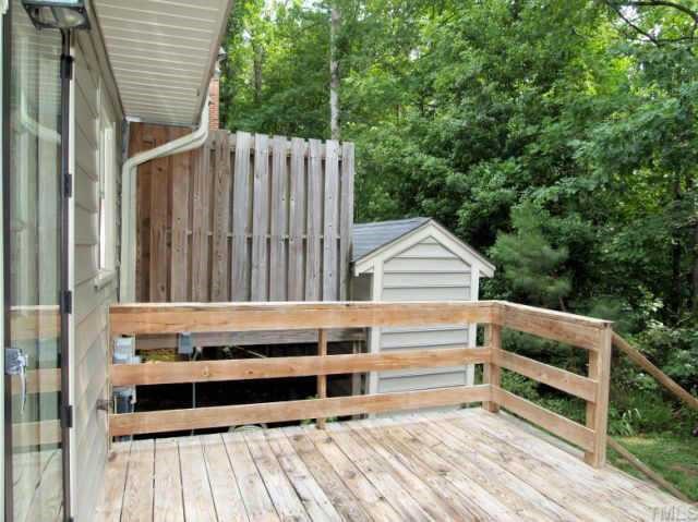 5572 Hamstead Crossing Raleigh, NC 27612 - Photo 8 of 8 a view of backyard with a deck and a garden