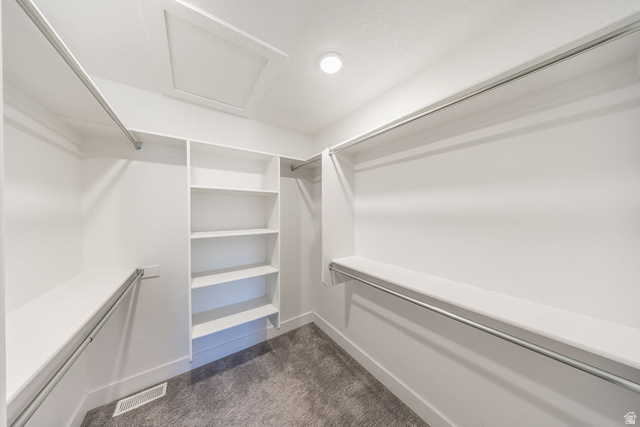 4991 South 475 West Washington Terrace, UT 84405 - Photo 22 of 31 Walk-in closet featuring built-in shelving, multiple hanging rods, and recessed lighting