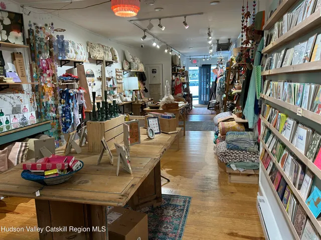 a view of a living room with furniture and a book shelf
