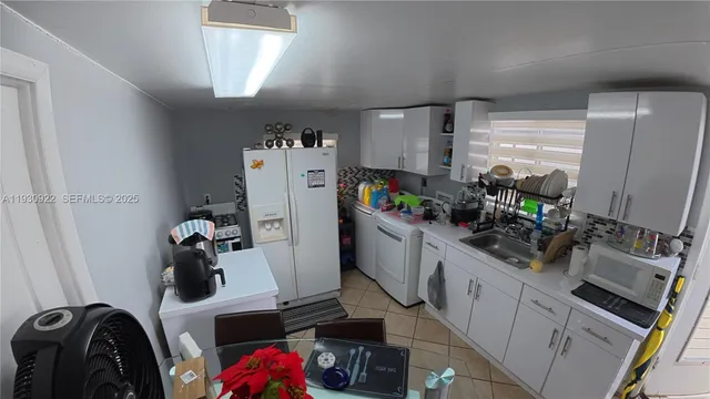 a kitchen with a sink and cabinets