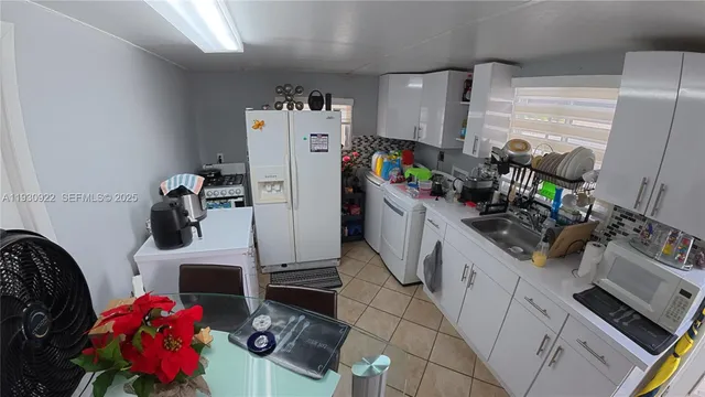 a kitchen with stainless steel appliances granite countertop a refrigerator stove top oven and sink
