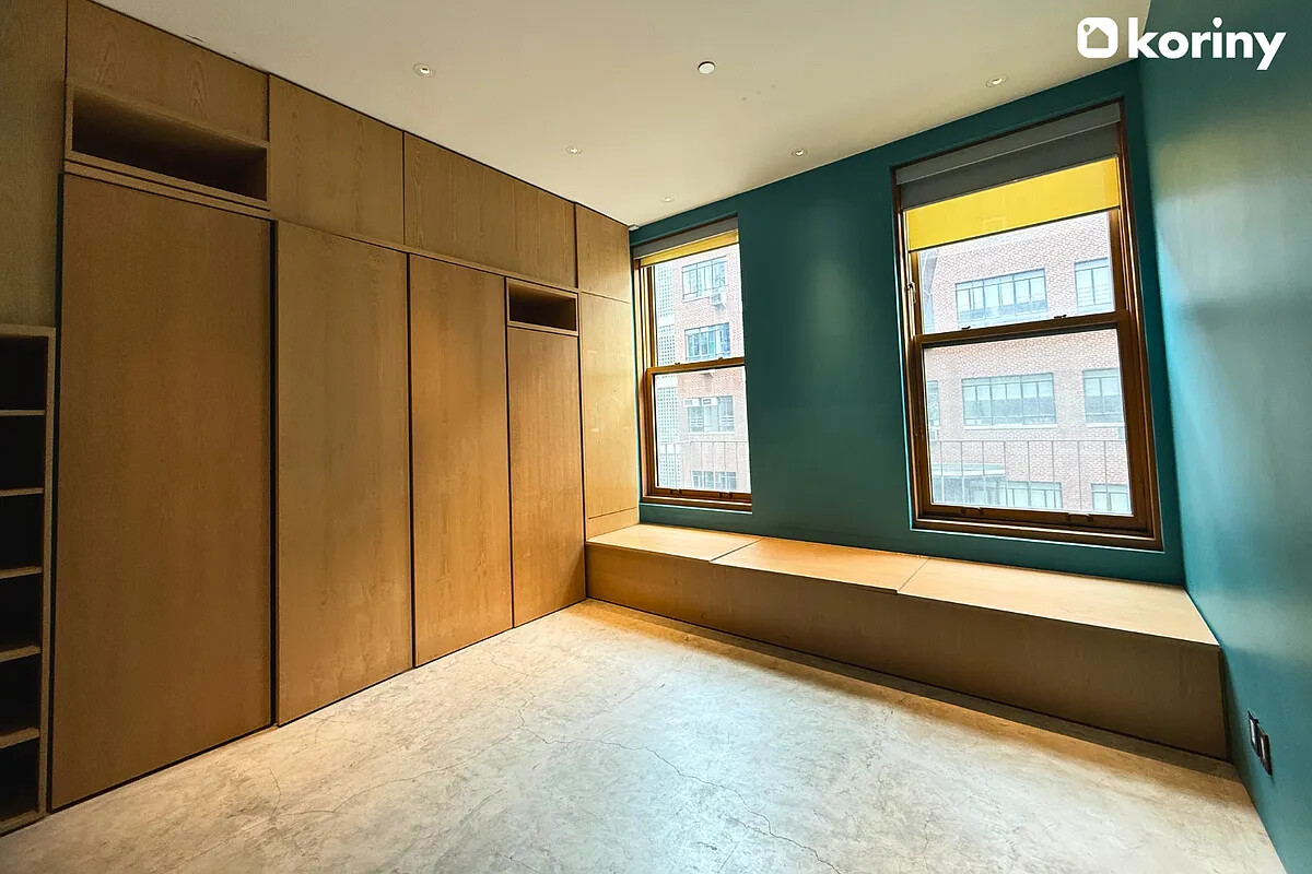 75 Warren Street Brooklyn, NY 11201 - Photo 18 of 39 a bedroom with a bed and a large window