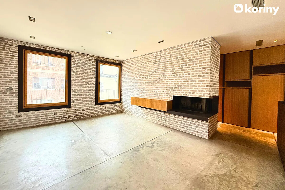 75 Warren Street Brooklyn, NY 11201 - Photo 2 of 39 a view of an empty room with a fireplace and a window