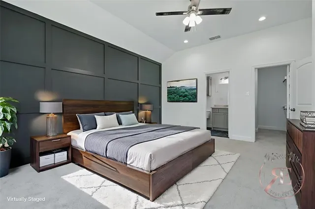 a bedroom with a large bed and a chandelier