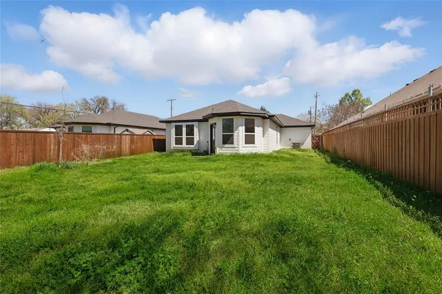 a view of a house with a yard and sitting area