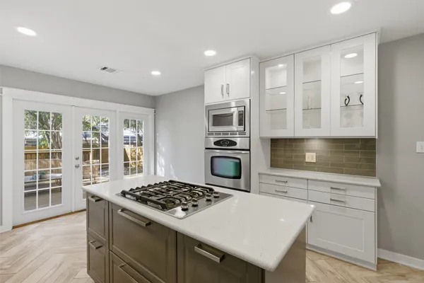 a kitchen with granite countertop a stove and a sink