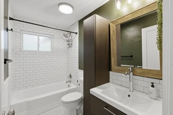a bathroom with a sink mirror toilet and bathtub