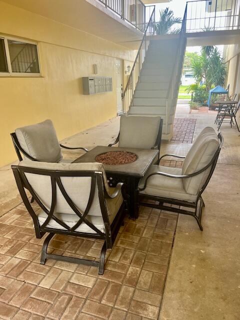 727 Hummingbird Way, Unit 1 North Palm Beach, FL 33408 - Photo 2 of 13 a balcony with chairs and a table