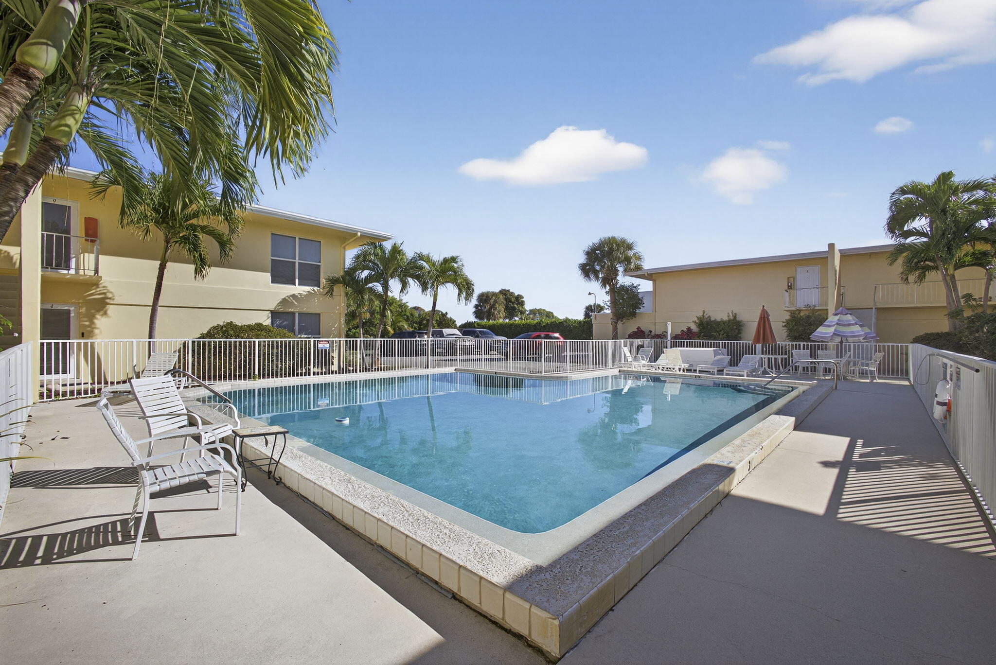 727 Hummingbird Way, Unit 1 North Palm Beach, FL 33408 - Photo 9 of 13 a view of a swimming pool with a patio and a yard