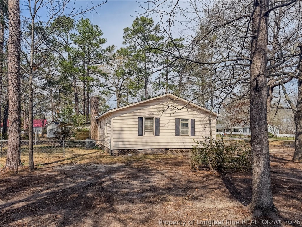 575 Veterans Road St. Pauls, NC 28384 - Photo 20 of 27 a white house that has a tree in front of it