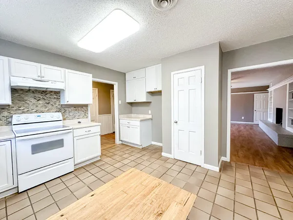 a kitchen with a stove a sink and a refrigerator