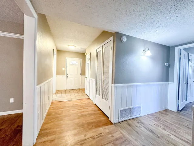 a view of a hallway with wooden floor