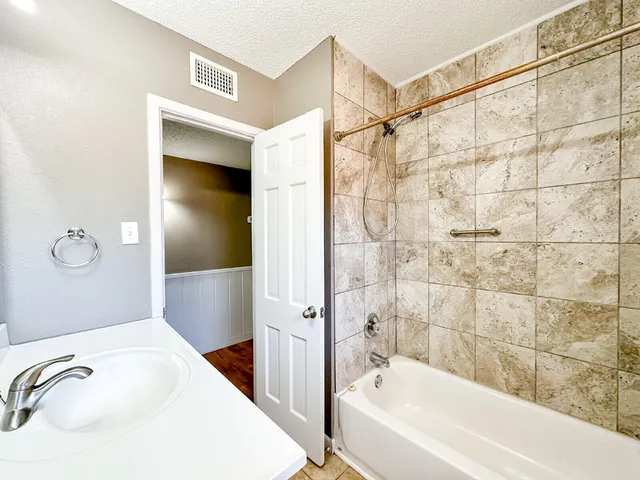 a bathroom with a bathtub and shower